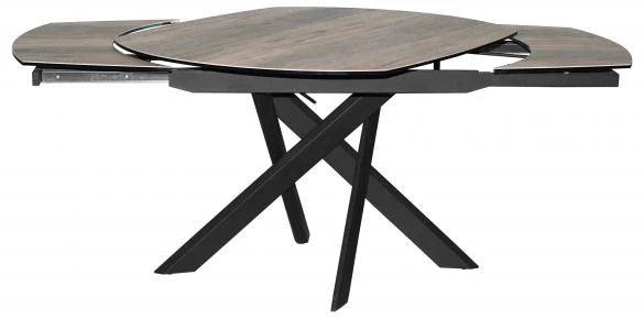 Expandable dining table with a dark wood grain oval leaf-shaped top and a black metal X-frame base, shown partially extended on a white background.