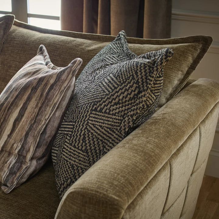 Sofa with textured olive-brown upholstery and assorted decorative cushions